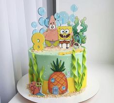 a spongebob themed birthday cake with pineapples and other cartoon characters on it