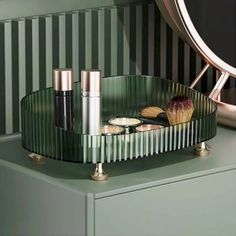 a green dresser with some cosmetics on it