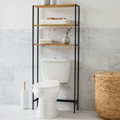 a white toilet sitting in a bathroom next to a shelf