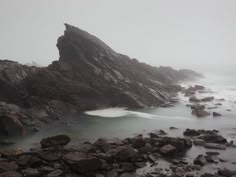 the rocks are covered in water and fog