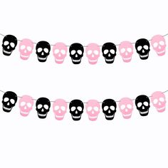 a pink and black skull garland with skulls hanging from it's sides, on a white background