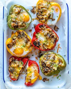 stuffed bell peppers with mushrooms and cheese on a white tray