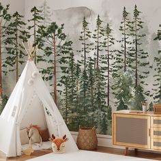 a teepee tent in front of a forest wall mural