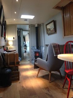 a living room filled with furniture and a fire place next to a dining room table