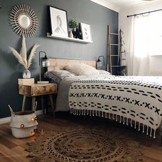 a bedroom with a bed, rug and pictures hanging on the wall above it's headboard