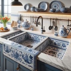 a kitchen with blue and white tiles on the counter top, sink and utensils