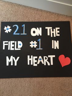 a sign that says 21 on the field 1 in my heart and has hearts painted on it