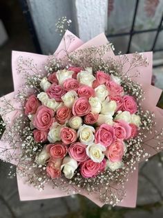 a bouquet of pink and white roses