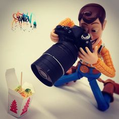 a toy photographer taking pictures with his camera