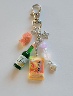 a bottle and some charms on a white surface