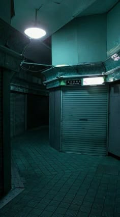 an empty storage room with the door open and lights on in the dark above it