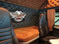 the inside of a vehicle with leather seats and an eagle emblem on the side wall