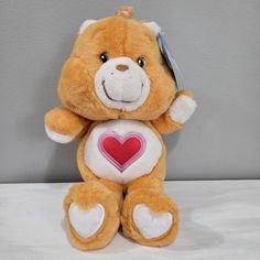 a brown teddy bear with a heart on it's chest