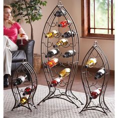 a woman sitting in a chair next to a wine rack