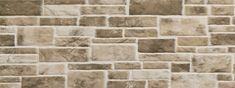 a stone wall made up of small squares and rectangles in shades of beige