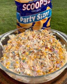 a bowl of party size corn salad next to a bag of scoops