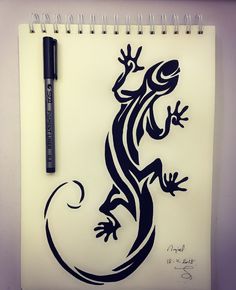 a black and white drawing of a lizard on a sheet of paper with a marker