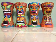 three colorfully painted vases sitting on top of a counter