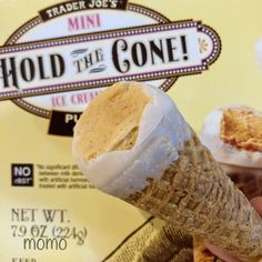 an ice cream cone is being held up