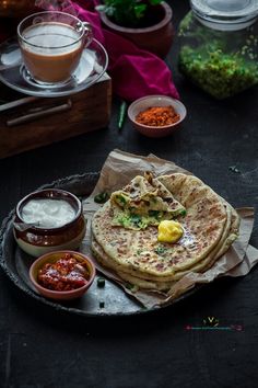 some food is sitting on a plate with sauces and condiments around it