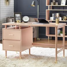 a pink desk with two drawers and a clock on the top shelf next to it