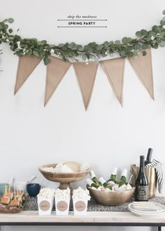 a table topped with lots of food next to a sign that says stop the mountain spring party