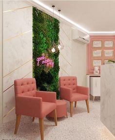 two pink chairs in front of a green wall with the words happy birthday on it