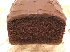 a piece of chocolate cake sitting on top of a wooden cutting board