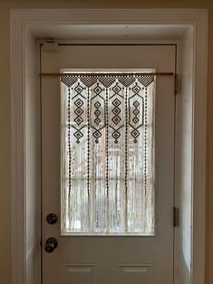 a white door with a window covered in beaded curtains on the front and side