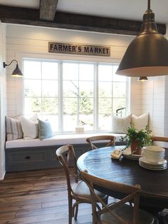 a dining room table with chairs and a bench in front of a window that reads farmer's market