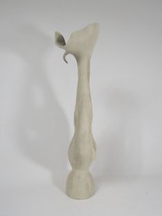 a white ceramic vase with a long neck