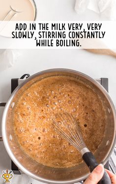 someone is whisking something in a pan with milk on the stove and text overlay reads add in the milk very very slowly, stir - stirring constantly while boiling