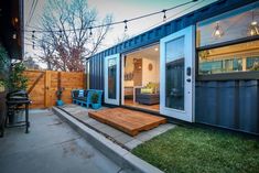 a backyard area with a deck, patio and shipping container