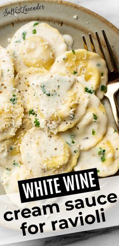 white wine cream sauce for ravioli is served on a plate with a fork and knife