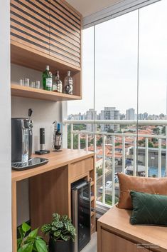 a kitchen with wooden cabinets and windows overlooking the city