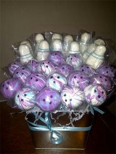 purple and white chocolate covered candies in a gift box