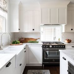 a kitchen with an oven, sink and counter tops in white painted wood paneling