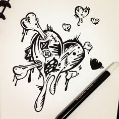 a drawing of a heart and bones on a piece of paper next to a pen