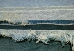 two pieces of blue and white fabric with fringes