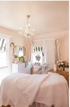 a bedroom with pink walls and white furniture