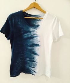 a white and blue shirt hanging on a hanger