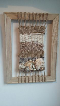 a frame with shells in it hanging on the wall