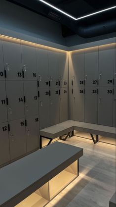 lockers are lined up against the wall with lights on them and benches in front of them