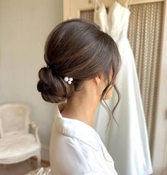 a woman is looking at her wedding dress