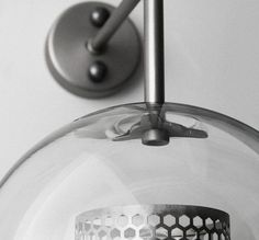 a close up of a light fixture on a white wall with hexagonal design