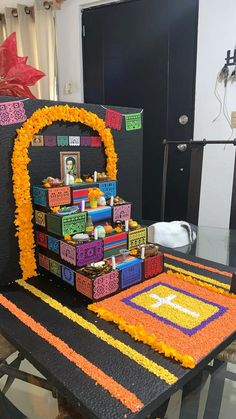 a cake made to look like it is decorated with blocks and flowers on the table