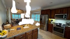 a large kitchen with stainless steel appliances and granite counter tops is pictured in this image