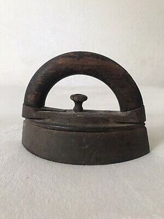 an old fashioned iron with a wooden handle