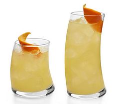 two tall glasses filled with lemonade and an orange peel on the rim, sitting next to each other