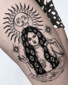 a woman's thigh with a sun and moon tattoo design on her leg,